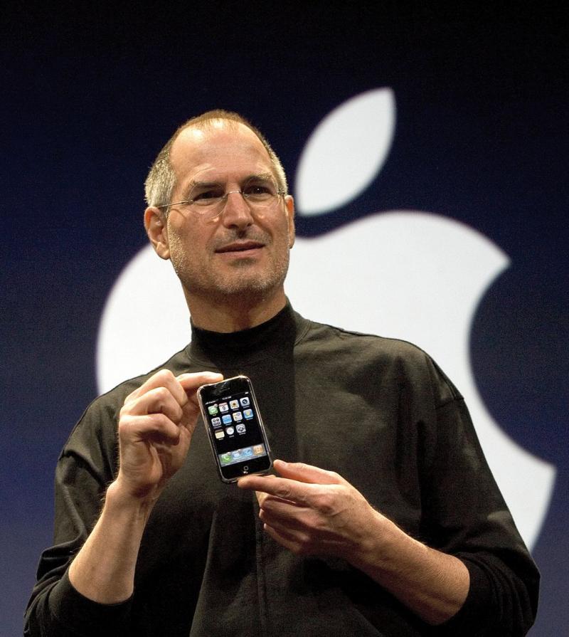 苹果已故创办人乔布斯出席2004年的iPhone 4推介仪式。iPhone 4至今依然被认为是划时代的产品,引领全球手机产业往触屏智能手机过渡。(互联网)